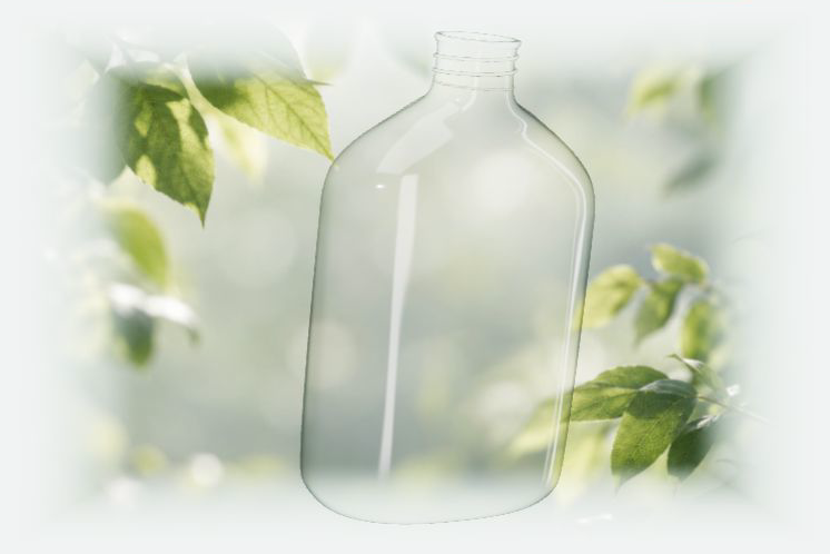 Transparent bottle forming against green leaves